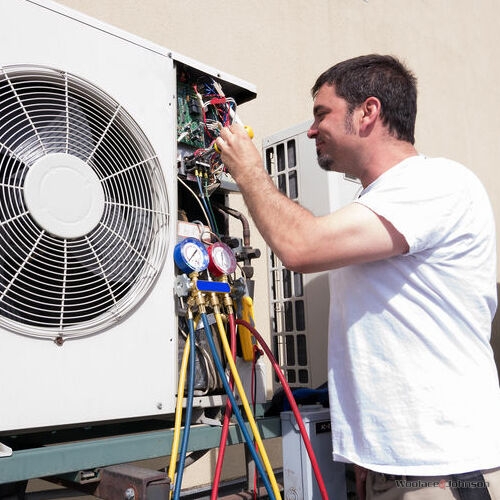 An HVAC Technician Makes Repairs.