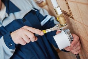 Plumber conducts gas line repair for a damaged line.