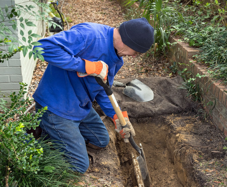 Digging Up Trench for Sewer Line Repair